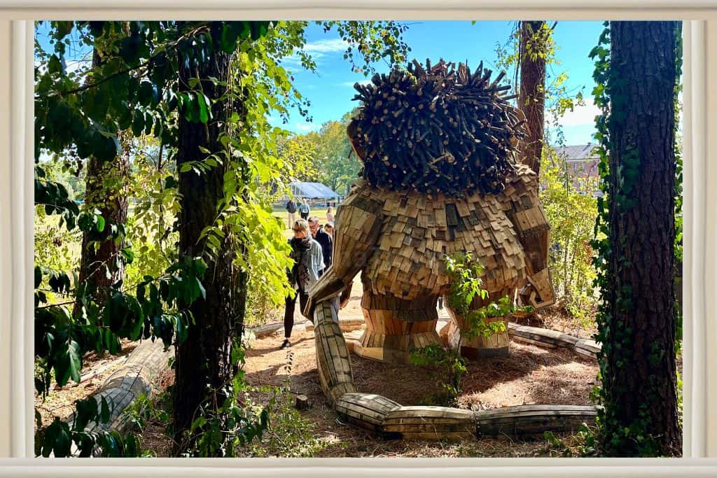 baby troll holding Momma troll's tail. 
Thomas Gambo's Trolls at Dix Park: Raleigh