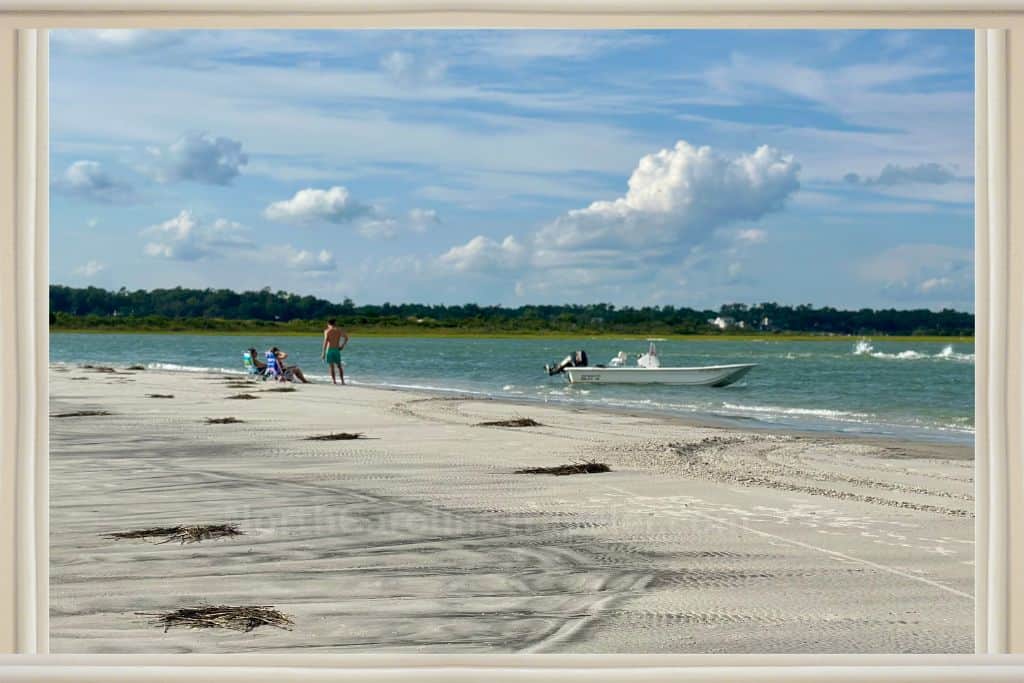 A boat and boaters resting on Shell Island. 

Shell Island Resort Wrightville Beach NC